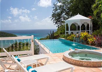 A gazebo on a patio offers a scenic view of the ocean, framed by the beauty of the Italian landscape.