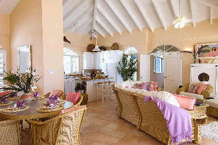 A cozy living room featuring a dining table surrounded by chairs, creating a welcoming space for gatherings.