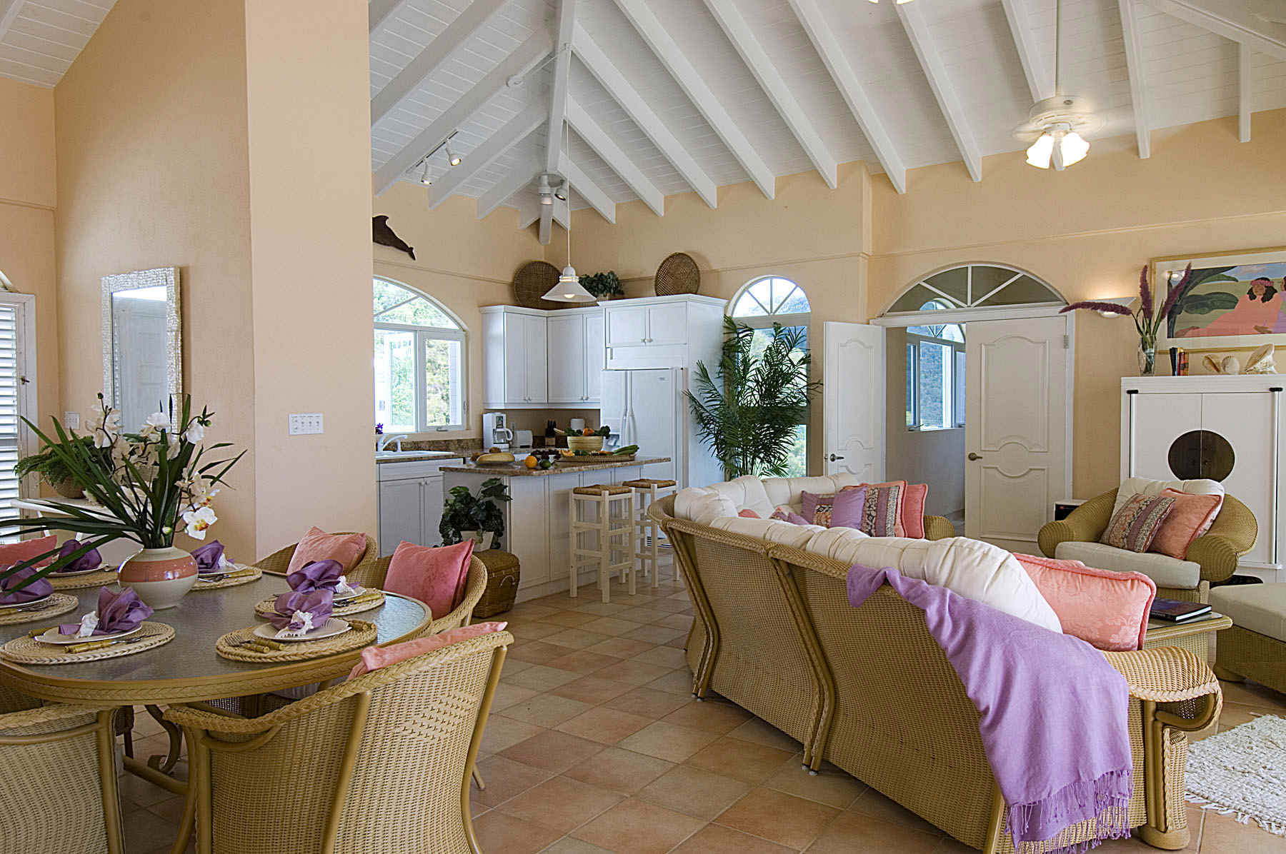 A cozy living room featuring a dining table surrounded by chairs, creating a welcoming space for gatherings.